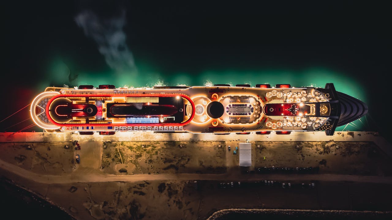 The Art of Drawing Readers In: Your attractive post title goes here Stunning aerial night view of a luxury cruise ship moored in Civitavecchia, Italy.