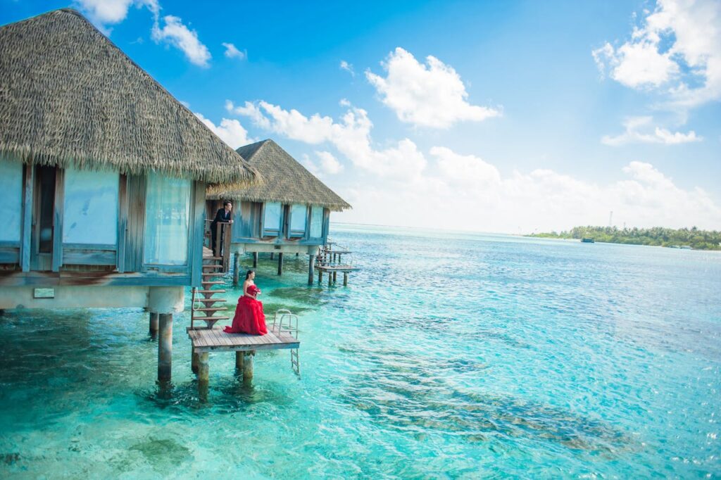 Mastering the First Impression: Your intriguing post title goes here Idyllic Maldives overwater bungalows with turquoise lagoon and a couple enjoying paradise.